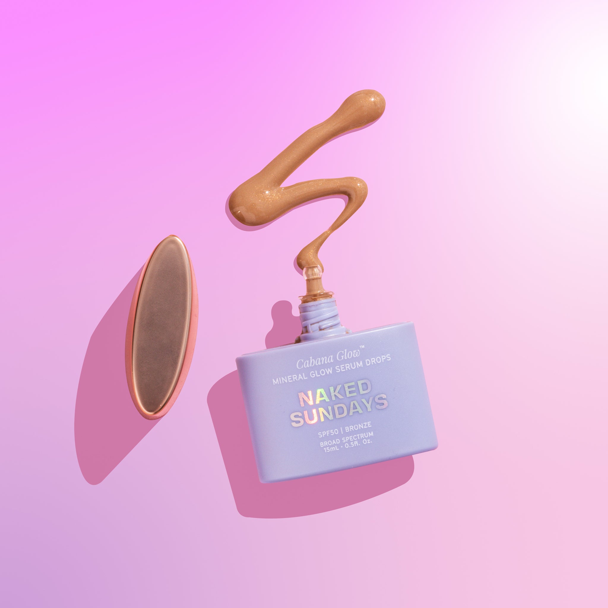 A bottle of CabanaGlow SPF50 Mineral Glow Serum Drops Mini in Bronze against a pink background.