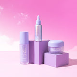 Skincare bundle products displayed on purple stands with a pink gradient background