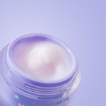 Jar of face cream with 'Naked Sundays' branding on a light purple background