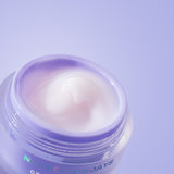 Jar of face cream with 'Naked Sundays' branding on a light purple background