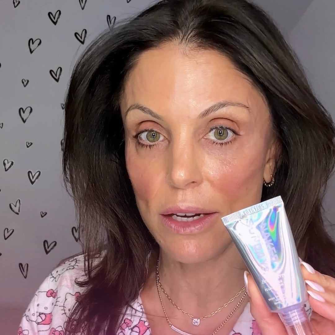 Bethenny Frenkel holding a BeautyScreen product with a heart patterned background