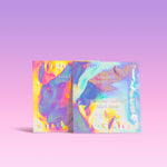 Two sheet masks with colorful, iridescent packaging on a light purple background.