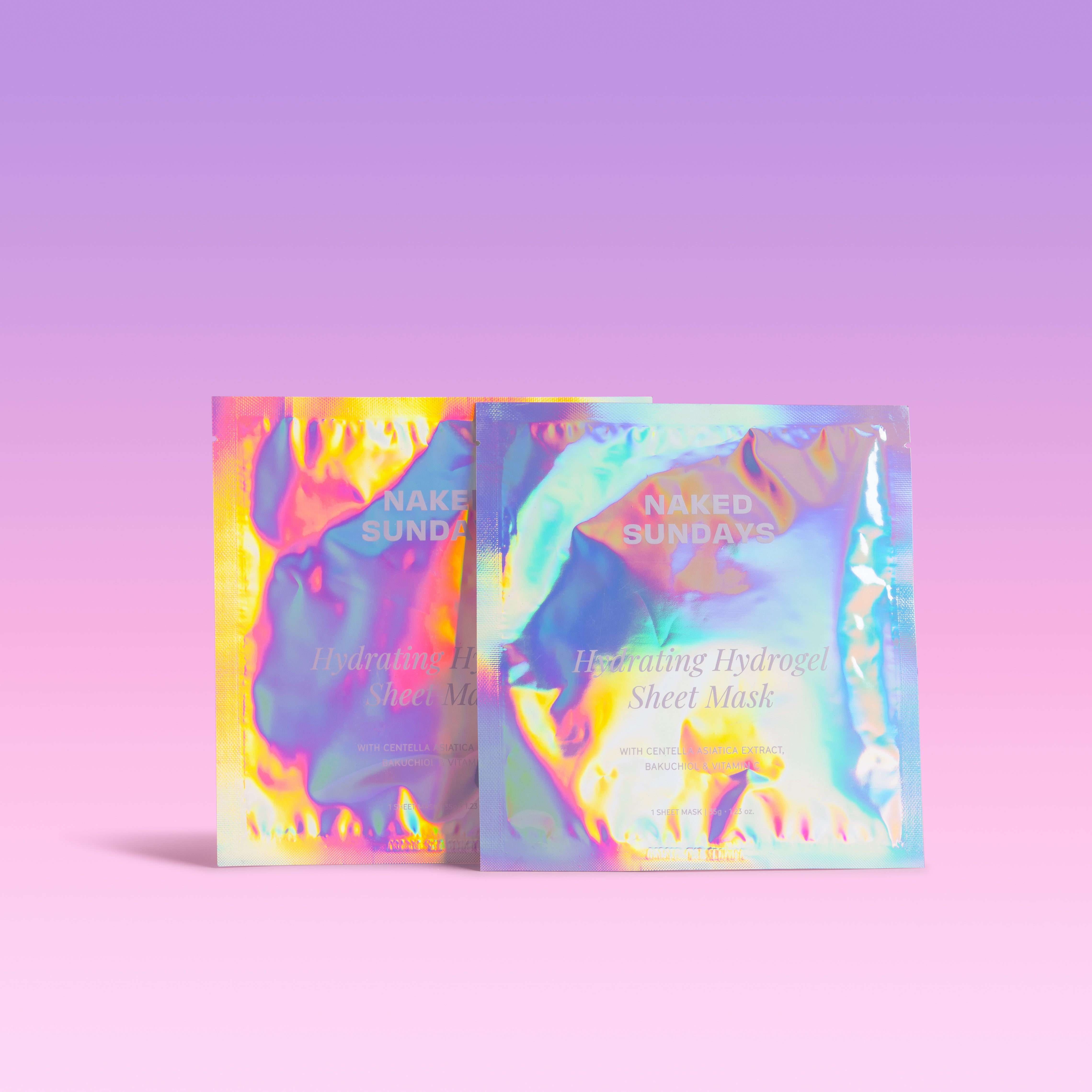 Two sheet masks with colorful, iridescent packaging on a light purple background.