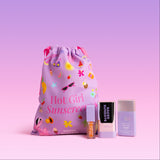 Naked Sundays drawstring bag with 'Hot Girl Sunscreen' text and three Glow products: Clear Glow Sun Stick, Cabana Glow Mineral Glow Serum Drops and Glow + Go Lip Oil in Salted Caramel.