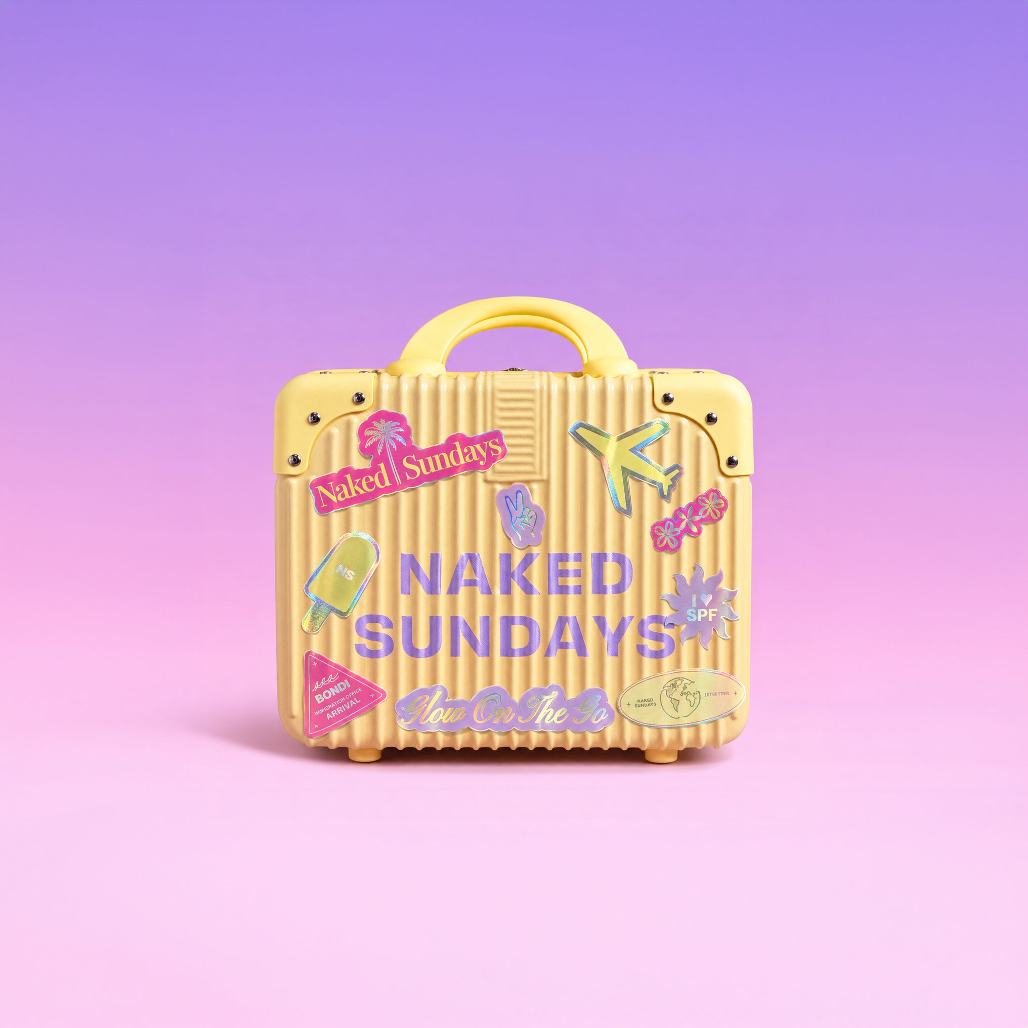 A small yellow ribbed suitcase with a handle, decorated with colorful travel-style stickers and the words 'NAKED SUNDAYS' on the front, set against a soft pink-to-purple gradient background.